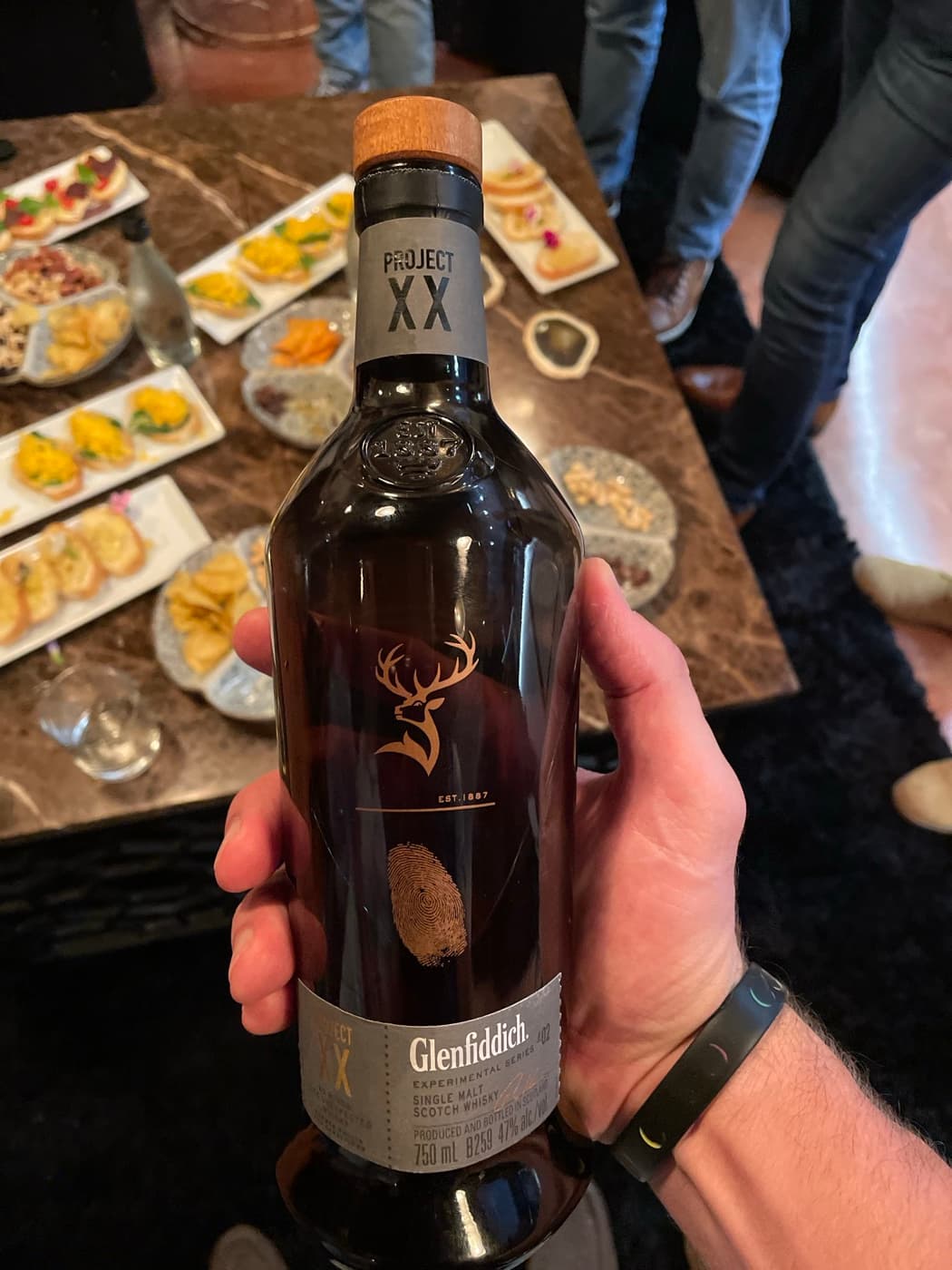 A whisky tasting in progress with food platters