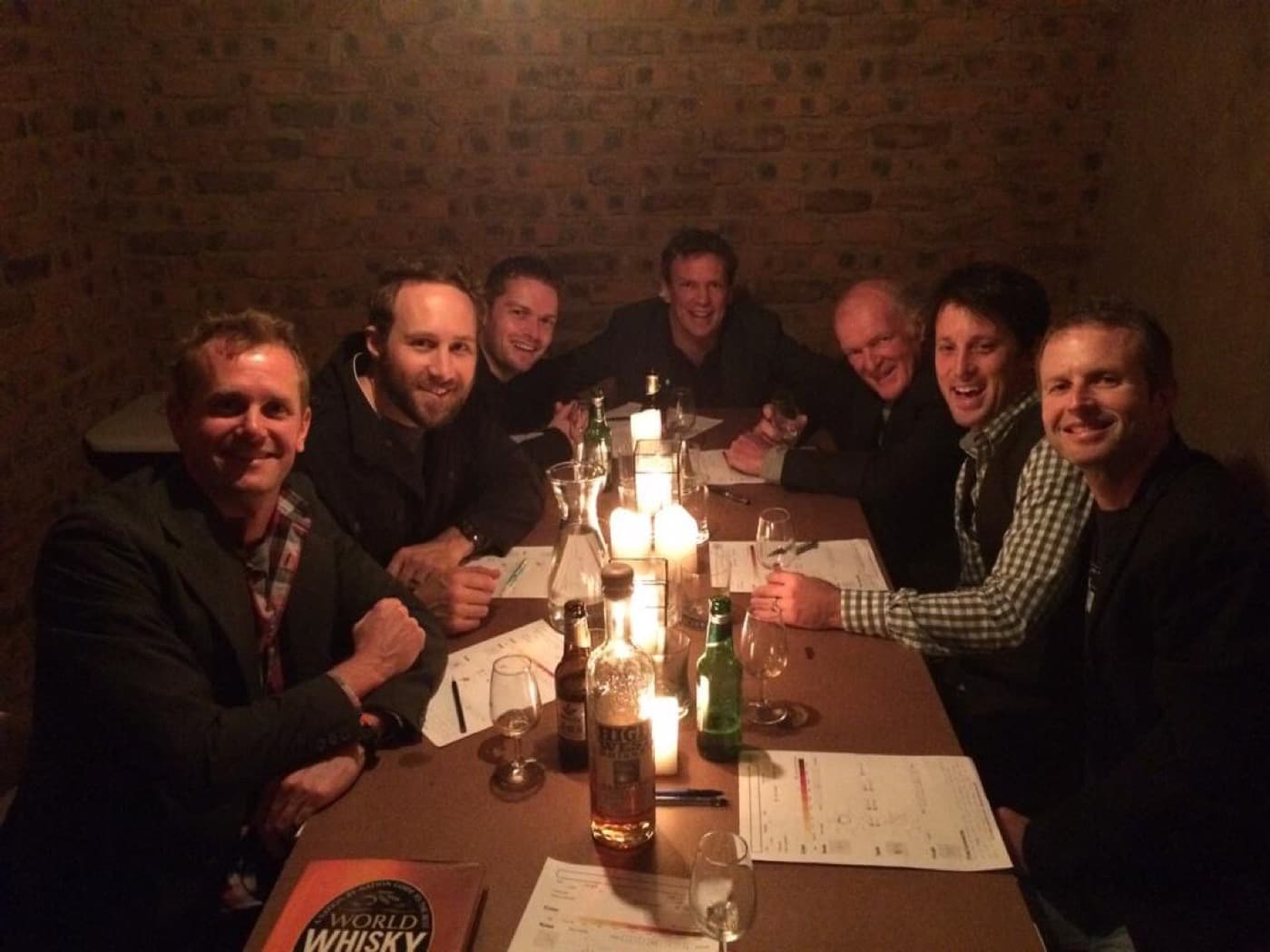 All eight WhiskyChilled founding members around the table by candlelight